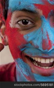 Man&rsquo;s face covered in holi colours