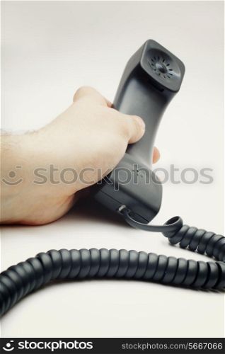 man&rsquo;s hand holding the phone close-up