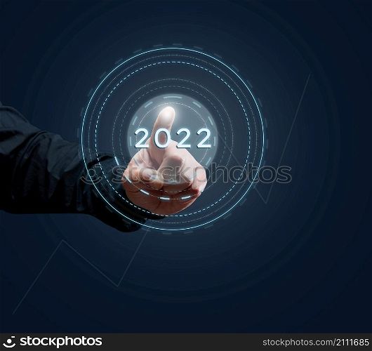 man&rsquo;s hand of a businessman presses on the virtual button of the beginning of the year. Business opening and new sales markets, the beginning of a new life