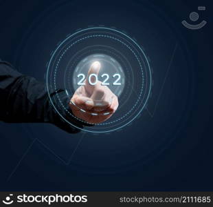 man&rsquo;s hand of a businessman presses on the virtual button of the beginning of the year. Business opening and new sales markets, the beginning of a new life