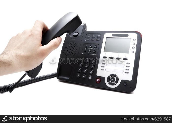 Man&rsquo;s hand with the handset and the phone isolated on white background