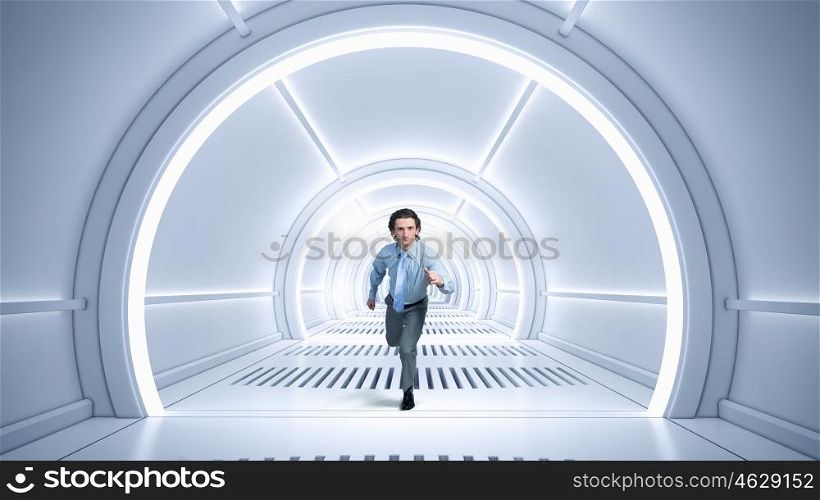 Man run in virtual room. Young businessman running in futuristically designed tunnel