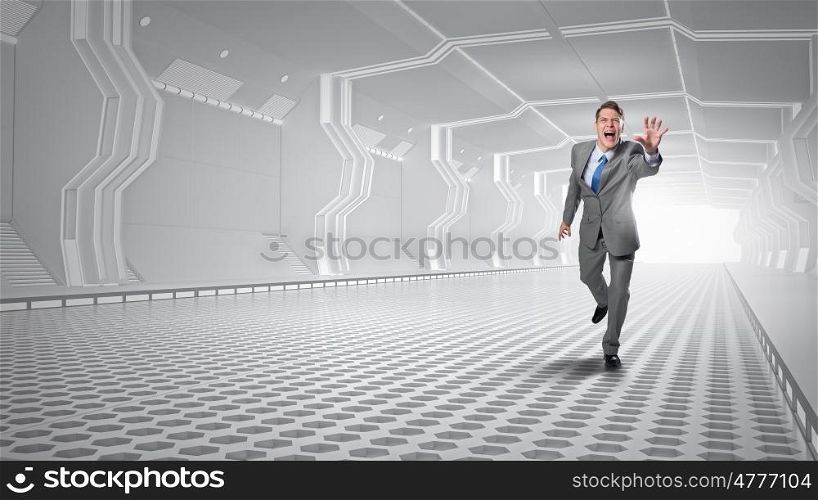 Man running and reaching hand. Young screaming businessman running in futuristic tunnel