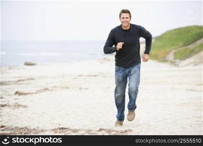 Man running at beach smiling