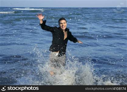 Man running happy on the blue summer beach, sunny summer