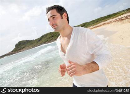 Man running on a sandy beach