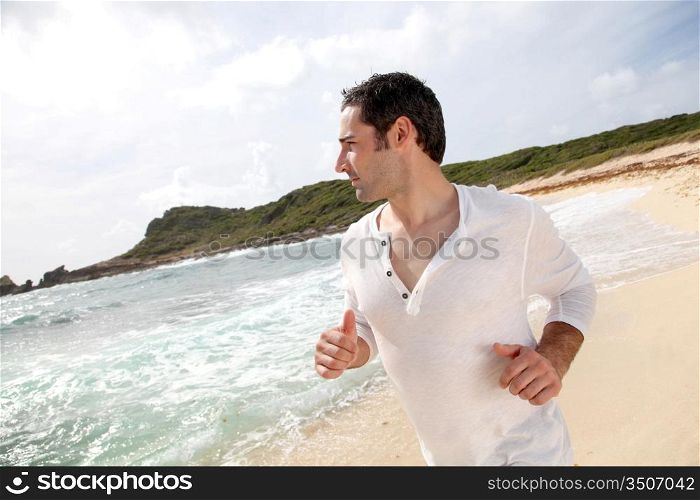 Man running on a sandy beach