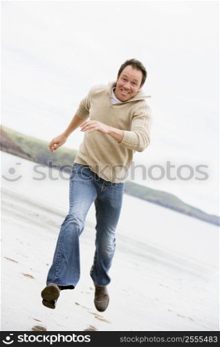 Man running on beach smiling