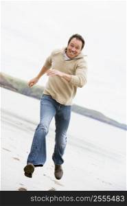 Man running on beach smiling