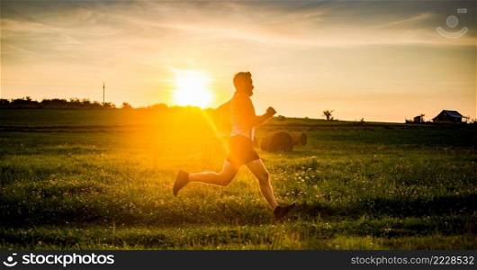 man running on meadow at sunset active lifestyle