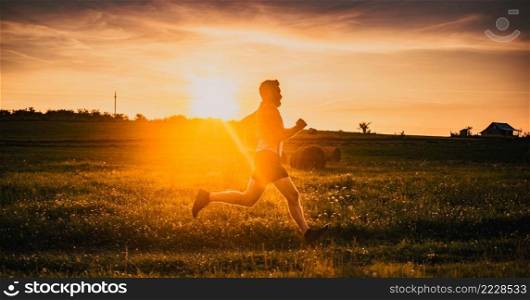 man running on meadow at sunset active lifestyle