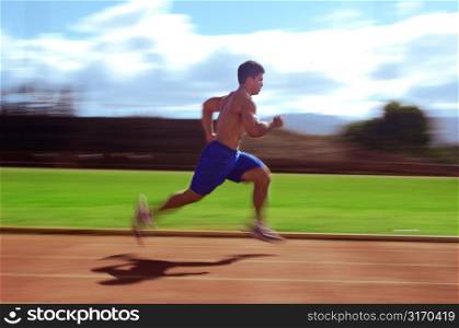 Man Running on Track With Shirt Off