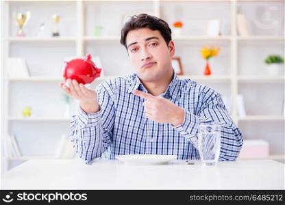 Man running out of money in restaurant and using savings from pi. Man running out of money in restaurant and using savings from piggy bank. Man running out of money in restaurant and using savings from pi