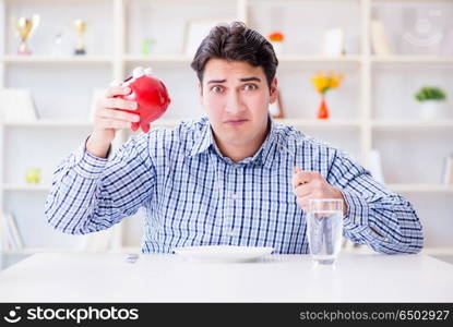 Man running out of money in restaurant and using savings from pi. Man running out of money in restaurant and using savings from piggy bank. Man running out of money in restaurant and using savings from pi