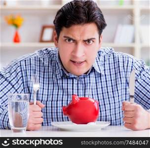 Man running out of money in restaurant and using savings from piggy bank. Man running out of money in restaurant and using savings from pi