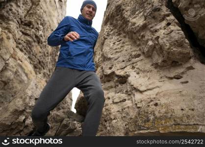 man running through rocks