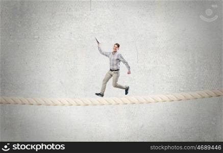 Man running with book. Funny student guy running on rope with opened book in hand