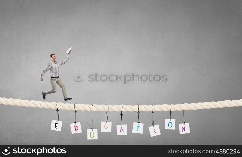 Man running with book. Funny student guy running on rope with opened book in hand