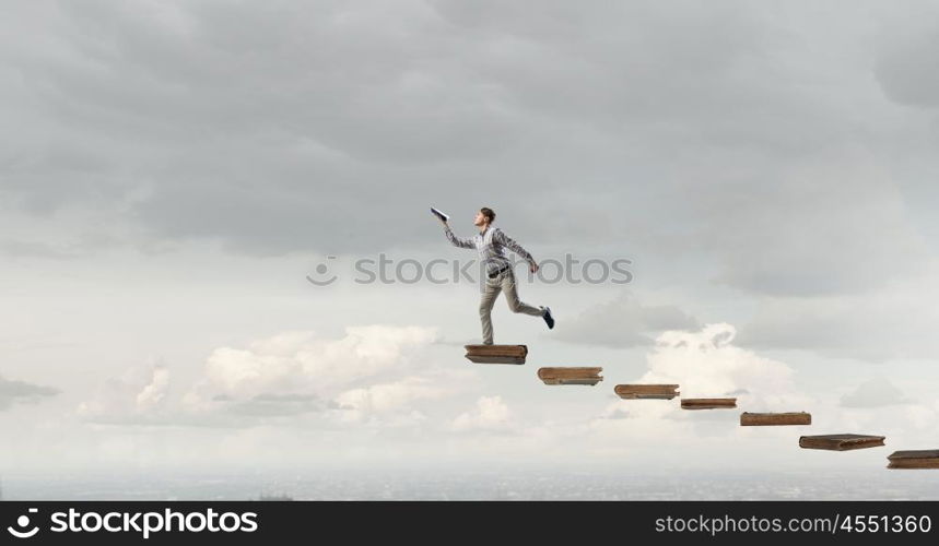 Man running with book. Funny student guy running with opened book in hand