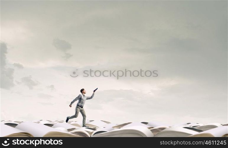 Man running with book. Funny student guy running with opened book in hand