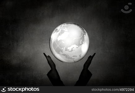 Man's hand holding digital Earth planet representing global technologies concept