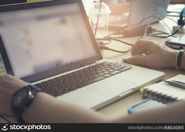 man's hand using laptop computer notebook, vintage tone