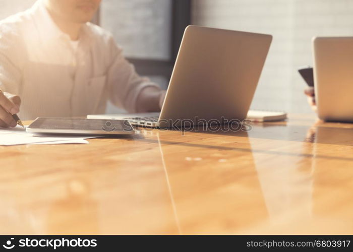 man's hand with laptop computer notebook and business document, selective focus and vintage tone