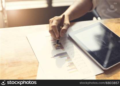 man's hand with tablet and business document, selective focus and vintage tone