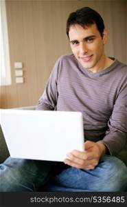 Man sat at home with a laptop