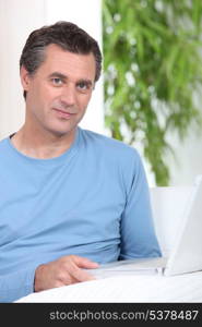 Man sat at table with computer