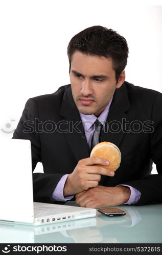 Man sat eating hamburger