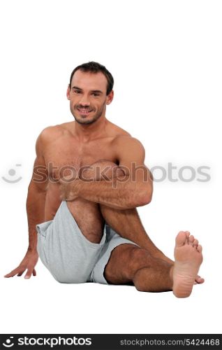 Man sat on the floor stretching