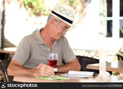 Man sat reading book on terrace