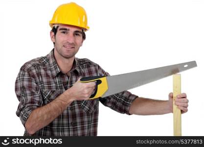 Man sawing plank of wood