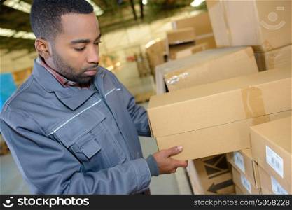 Man selecting boxes in warehouse