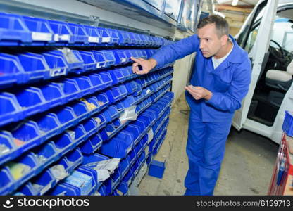 Man selecting part from racking