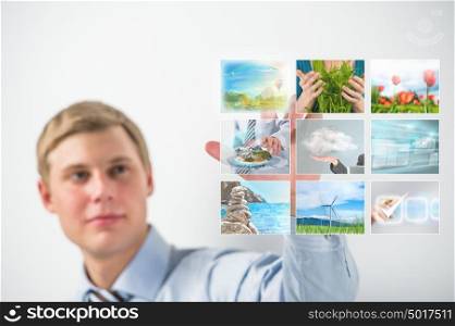 Man selecting tv channel on virtual touch screen
