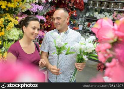 man sells flowers in the flower shop