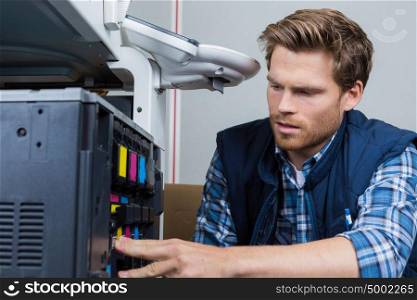 Man servicing photocopier