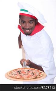 Man serving a pizza on a wooden peel (board)