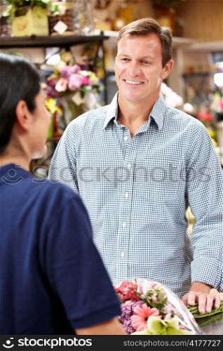 Man serving customer in florist