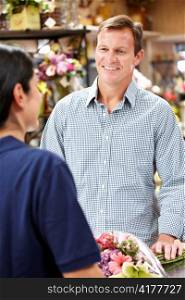 Man serving customer in florist