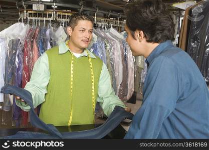 Man serving customer in the laundrette