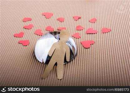 Man shape cut out of paper on paper background