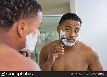 Man Shaving in Mirror
