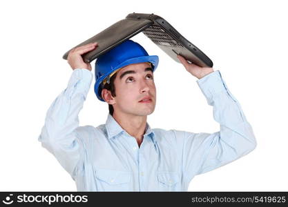 Man sheltering under laptop