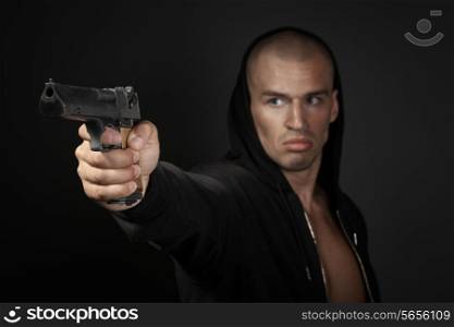 man shooting gun isolated on gray background. focus on gun