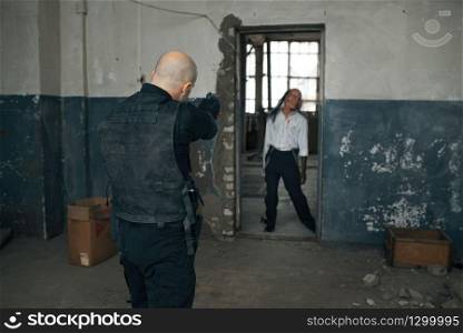 Man shoots zombie, nightmare in abandoned factory, bullet effect. Horror in city, creepy crawlies, doomsday apocalypse. Man shoots zombie, nightmare, bullet effect