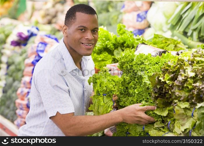Man shopping for lettuce at a grocery store
