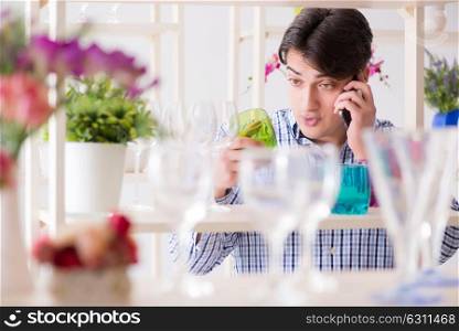 Man shopping in shop and calling his wife